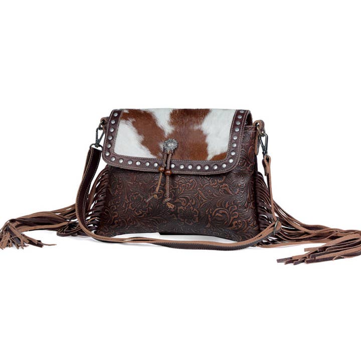 Carved Blossoms Leather &amp; Hairon Bag has a 22" strap