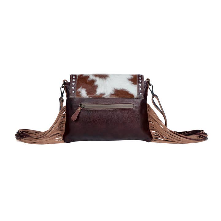Carved Blossoms Leather &amp; Hairon Bag has an exterior zippered pocket