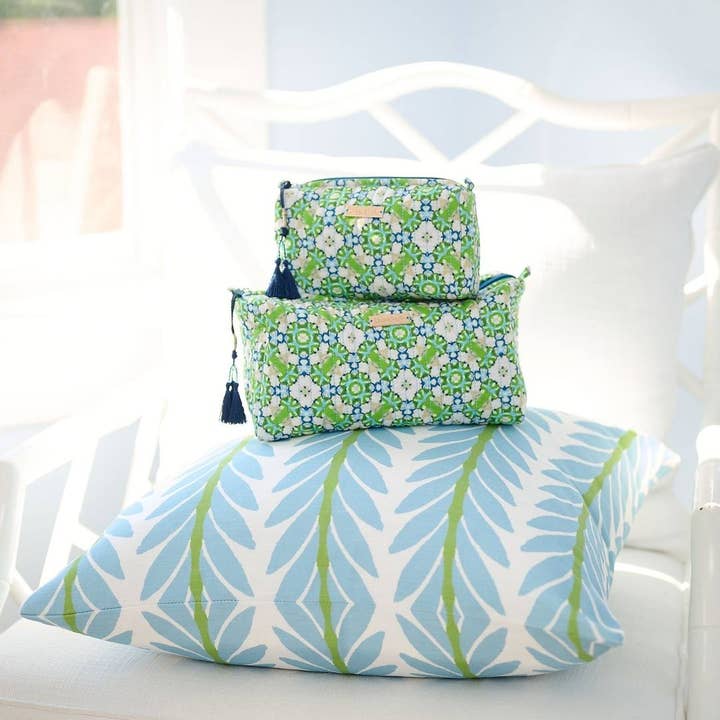 Serendipity Cosmetic Bag shown in both sizes on decorative pillow