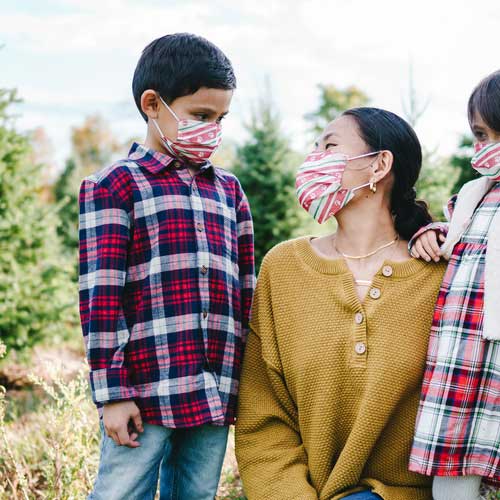Holiday Paws Kid&#39;s Face Mask disposable with paw prints on red ribbon mother and son