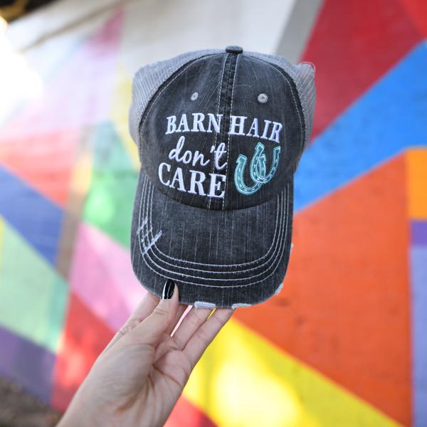 Barn Hair Don&#39;t Care embroidered trucker hat with mint horseshoes by Katydid, held by woman