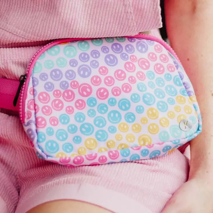 Pastel Happy Face Belt Bag in a multicolor pastel happy face pattern, wear it as a fanny pack or crossbody bag.
