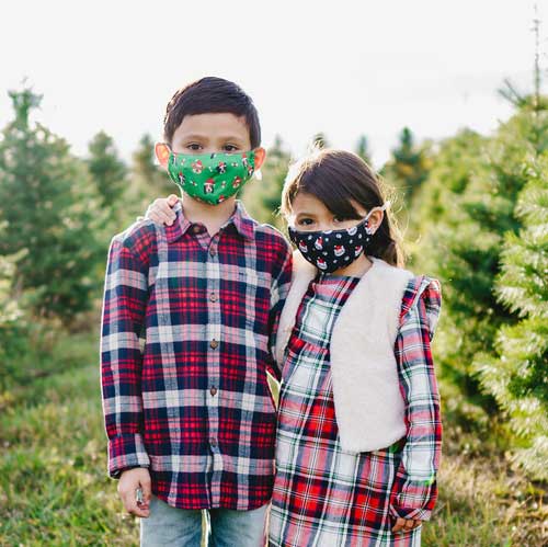 Santa Cat kid&#39;s face mask with cats in red caps and paw prints children outdoors