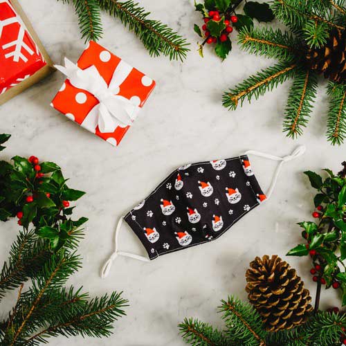 Santa Cat kid&#39;s face mask with cats in red caps and paw prints under Christmas tree