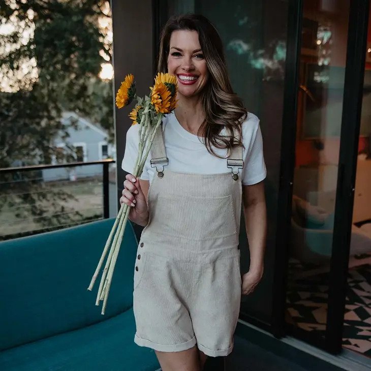 Tan Basic Corduroy Overalls worn by model holding sunflowers