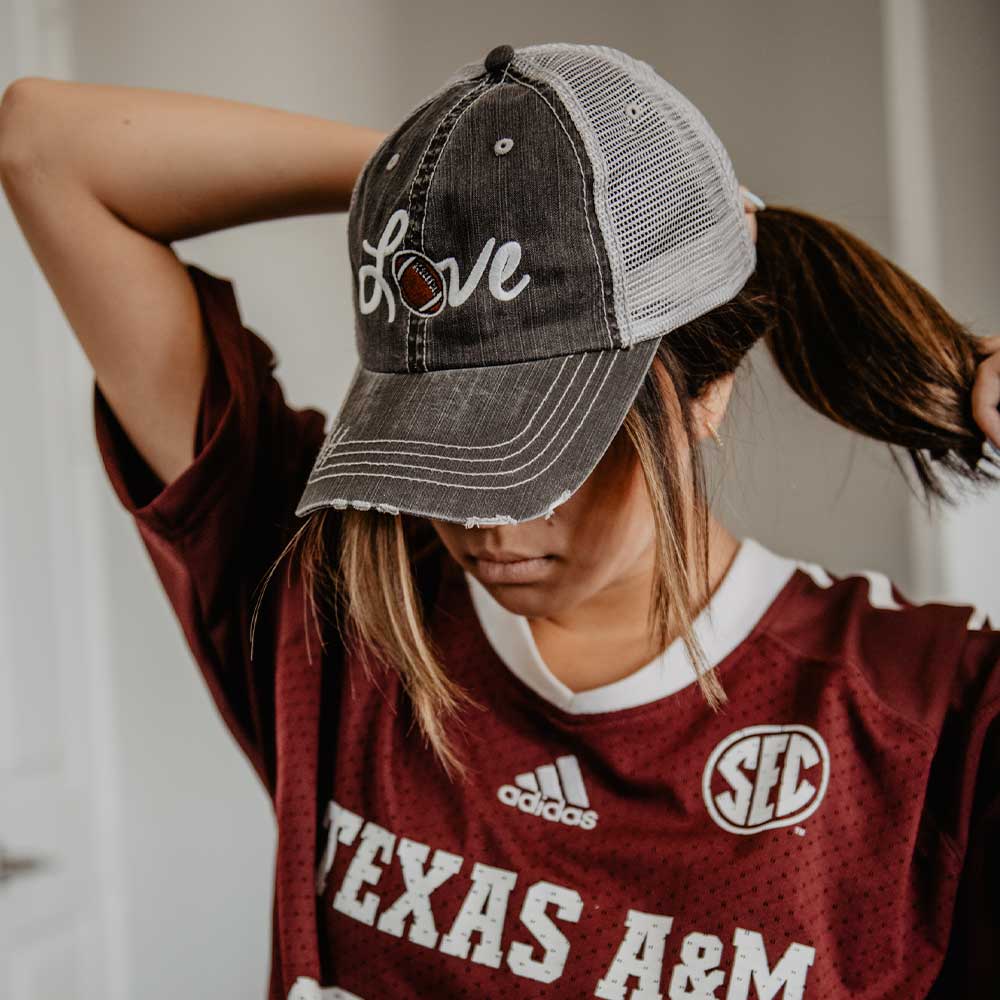 Love Football Women&#39;s Trucker Hat with embroidered Love and football, from Katydid. Lifestyle image