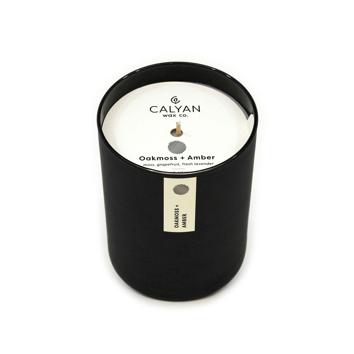 Oakmoss + Amber soy wax candle in black matte glass tumbler from Calyan Wax Co.
