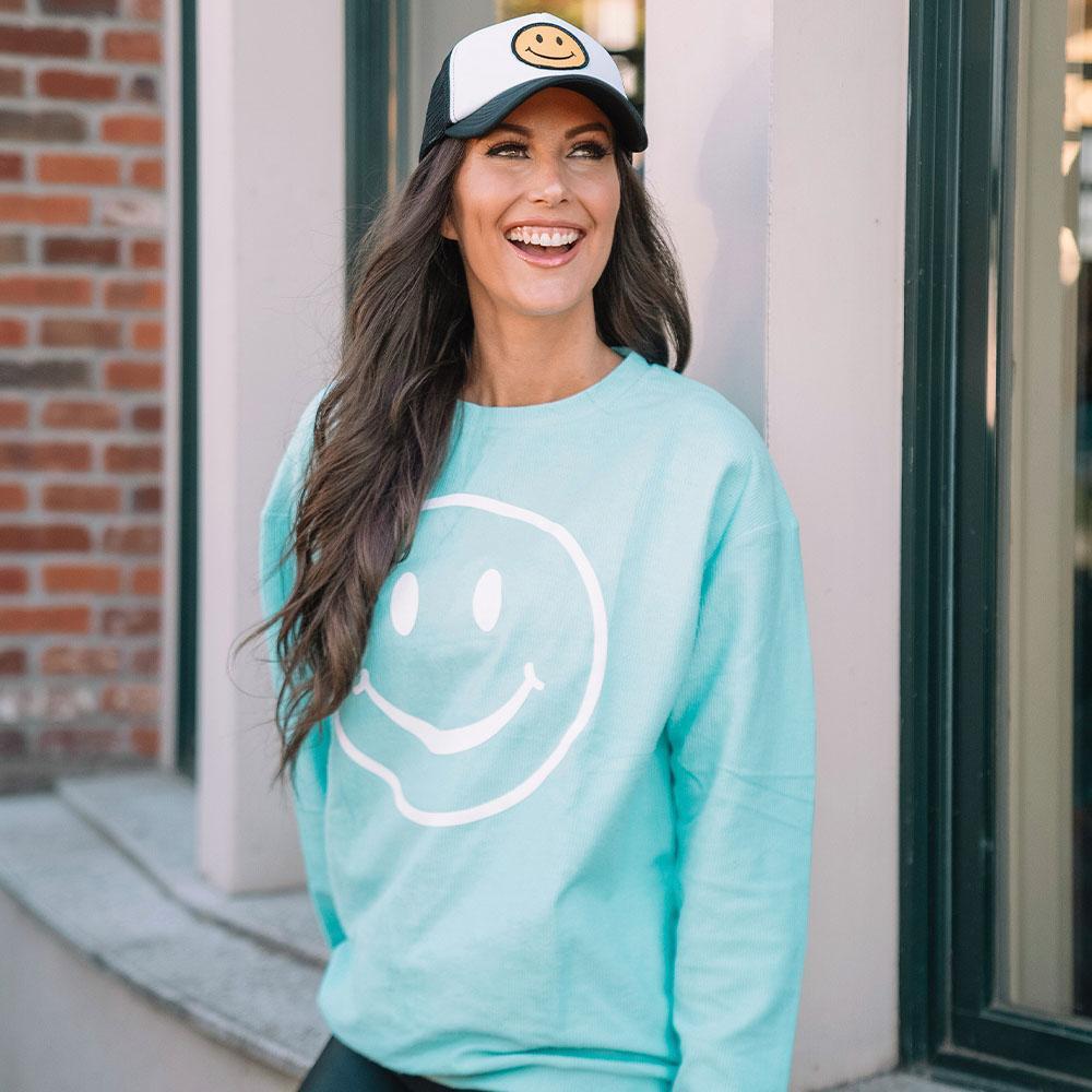 Happy Face Corded Sweatshirt in aqua worn by model with happy face cap